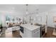 Open concept kitchen with island, stainless steel appliances, and hardwood floors at 2068 Jasmine St, Denver, CO 80207