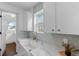 Updated laundry room with white cabinets and a stylish sink at 2068 Jasmine St, Denver, CO 80207