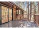 Large outdoor deck featuring wood construction with a tree-filled view at 8782 S Ault Ln, Morrison, CO 80465