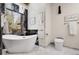 Luxurious bathroom with freestanding tub, marble finishes, and large windows overlooking the lush outdoors at 8782 S Ault Ln, Morrison, CO 80465