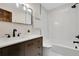 Sleek bathroom showcasing a modern vanity, a walk-in shower, and a skylight for natural lighting at 8782 S Ault Ln, Morrison, CO 80465