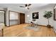 Bright bedroom featuring hardwood floors, built in shelves, and a ceiling fan at 8782 S Ault Ln, Morrison, CO 80465