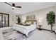 Tranquil bedroom featuring a ceiling fan, large windows, and ample space for comfortable living at 8782 S Ault Ln, Morrison, CO 80465