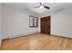 Well-lit bedroom features wood floors, a ceiling fan, natural light, and a spacious closet at 8782 S Ault Ln, Morrison, CO 80465