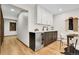 Contemporary dining area with stainless steel wine fridge, modern cabinets, and hardwood floors at 8782 S Ault Ln, Morrison, CO 80465