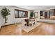 Dining room with hard wood floors, a bench seat, a large window, and neutral colored furniture at 8782 S Ault Ln, Morrison, CO 80465