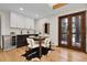 The dining room features double doors, hardwood floors and a modern bar area at 8782 S Ault Ln, Morrison, CO 80465