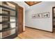 Bright foyer featuring wood floors and a modern door at 8782 S Ault Ln, Morrison, CO 80465