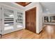 Bright foyer featuring wood floors and a modern door at 8782 S Ault Ln, Morrison, CO 80465