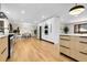 The open kitchen has modern appliances, sleek white cabinets, and hardwood floors at 8782 S Ault Ln, Morrison, CO 80465