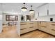 Eat-in kitchen with hardwood floors, quartz countertops, and modern light fixtures at 8782 S Ault Ln, Morrison, CO 80465
