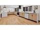 Modern kitchen with stainless steel appliances, quartz countertops, and a large island at 8782 S Ault Ln, Morrison, CO 80465