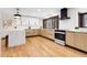 Bright kitchen featuring wood floors, quartz countertops, and stainless steel appliances at 8782 S Ault Ln, Morrison, CO 80465