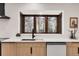 Kitchen with updated countertops, hardwood floors, and a garden view window at 8782 S Ault Ln, Morrison, CO 80465