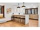 Bright kitchen featuring white cabinets and a breakfast bar at 8782 S Ault Ln, Morrison, CO 80465