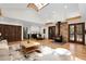 Bright living room with a wood burning stove, modern cabinetry, and glass patio doors at 8782 S Ault Ln, Morrison, CO 80465