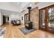 Living room and dining area with a wood burning stove, modern cabinetry, and glass patio doors at 8782 S Ault Ln, Morrison, CO 80465