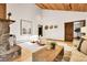 Cozy living room featuring a stone fireplace, vaulted ceilings, and hardwood floors at 8782 S Ault Ln, Morrison, CO 80465