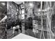 Modern walk-in shower featuring black marble tile and a rainfall shower head at 8782 S Ault Ln, Morrison, CO 80465