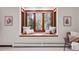 Cozy window seat with scenic views framed by dark-wood trim, providing a relaxing retreat within the bedroom at 8782 S Ault Ln, Morrison, CO 80465