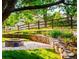 Stone fire pit area in a nicely landscaped backyard with wooden fence at 17053 E Jamison Ave, Centennial, CO 80016