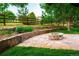 Picturesque backyard with stone fire pit and landscaping bordered by a wooden fence at 17053 E Jamison Ave, Centennial, CO 80016