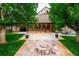 Inviting backyard featuring a stone patio with fire pit and string lights, perfect for outdoor entertaining at 17053 E Jamison Ave, Centennial, CO 80016