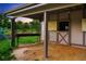 Rustic barn featuring a stall with metal bars and a functional sliding door, offering rural charm at 17053 E Jamison Ave, Centennial, CO 80016