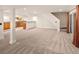 Large finished basement with a bar area, daylight windows, and access to the backyard at 17053 E Jamison Ave, Centennial, CO 80016