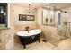 Luxurious bathroom featuring a clawfoot tub, glass-enclosed shower, and stylish chandelier at 17053 E Jamison Ave, Centennial, CO 80016