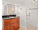 Bathroom with a wood vanity cabinet, granite countertop and walk-in shower visible in the mirror at 17053 E Jamison Ave, Centennial, CO 80016