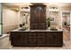 Elegant bathroom boasting a double vanity with granite countertops and rich, dark wood cabinetry at 17053 E Jamison Ave, Centennial, CO 80016