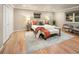 Comfortable bedroom with hardwood floors, neutral colors, and an inviting bed with decorative pillows at 17053 E Jamison Ave, Centennial, CO 80016