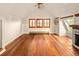Bright bonus room with hardwood floors, multiple windows, and a unique fireplace offering a cozy atmosphere at 17053 E Jamison Ave, Centennial, CO 80016