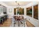Cozy dining area featuring modern lighting, hardwood floors, and large windows offering natural light at 17053 E Jamison Ave, Centennial, CO 80016