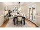 Formal dining room with elegant lighting, neutral walls, and access to the patio at 17053 E Jamison Ave, Centennial, CO 80016