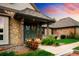 Inviting front entrance with stone accents, lush landscaping, and a covered porch at 17053 E Jamison Ave, Centennial, CO 80016