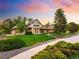 Charming home with brick and stone exterior, manicured lawn, and beautiful landscaping at 17053 E Jamison Ave, Centennial, CO 80016