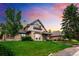 Attractive home with a well-maintained lawn, brick and stone accents, and a welcoming facade at 17053 E Jamison Ave, Centennial, CO 80016