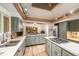 Open concept kitchen with island cooktop and wood beam ceiling at 17053 E Jamison Ave, Centennial, CO 80016