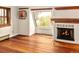 Inviting living area with hardwood floors, a fireplace, and a large window offering natural light and scenic views at 17053 E Jamison Ave, Centennial, CO 80016