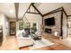 Inviting living room with a brick fireplace, hardwood floors, and views of the outdoors at 17053 E Jamison Ave, Centennial, CO 80016