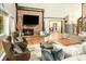 Bright living room showcasing a brick fireplace, hardwood floors, and comfortable seating at 17053 E Jamison Ave, Centennial, CO 80016