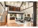 Cozy living room featuring a loft, hardwood floors, lots of windows and bar for entertaining at 17053 E Jamison Ave, Centennial, CO 80016