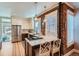 Kitchen with stainless steel appliances, breakfast bar, marble countertop, and exposed brick wall at 636 N Logan St, Denver, CO 80203