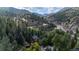 Aerial shot showcasing a winding road through a lush forest with houses nestled among the trees at 41 Silver Spruce, Boulder, CO 80302