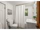 Bright bathroom featuring white walls, white fixtures, a shower-tub combo, and a window for natural light at 41 Silver Spruce, Boulder, CO 80302