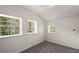 Well-lit bedroom with paneled walls and multiple windows providing natural light, complemented by neutral carpet at 41 Silver Spruce, Boulder, CO 80302