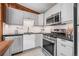 Updated kitchen features stainless steel appliances, under cabinet lighting, painted cabinets and wood trim at 41 Silver Spruce, Boulder, CO 80302