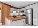 Renovated kitchen features stainless steel appliances, center island with butcher block countertop and wood wall trim at 41 Silver Spruce, Boulder, CO 80302